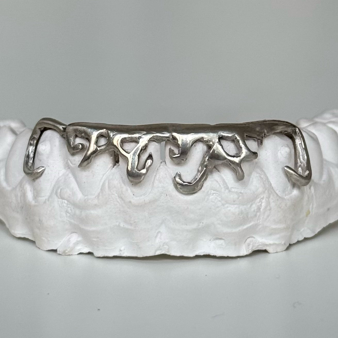 Custom abstract silver grillz by icyfangsldn